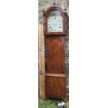 An Antique mahogany cased long case clock, with painted arched dial, inlaid decoration to the hood