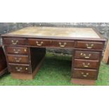 A mahogany pedestal partners desk, with writing surface, fitted with drawers around the kneehole