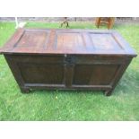 An antique oak coffer, having three fielded panels to the top, over two fielded panels to the front,