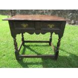 An antique oak table, fitted with a drawer and raised on turned legs, width 35.5ins x depth 22ins