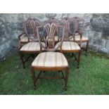 A set of six (4 + 2) shield back dining chairs, with pierced splat