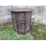 A small carved Eastern table, diameter 13ins x height 13ins