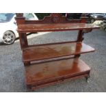 A Victorian style mahogany three tiered buffet, veneer and moulding missing, width 54ins x height
