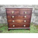 A 19th century mahogany chest of drawers, having two short drawers over three longer drawers, raised