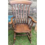 A Windsor style rocking chair, with spindles to the arms