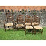 A harlequin set of six ladder back country chairs, with carved seat, four singles and two similar