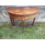 An Edwardian mahogany fold over table, with cross banded decoration, raised on reeded legs, width