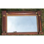 A rosewood framed wall mirror, of rectangular form with half column decoration, overall 17ins x