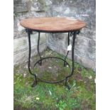 A Bromsgrove Guild occasional table, the circular oak top over wrought iron base, diameter 18ins x