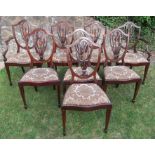 A set of eight (6+2) mahogany shield back dining chairs, with carved, pierced and inlaid