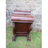 A 19th century rosewood piano top Davenport, having secret writing compartment and rising lid,