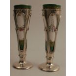 A pair of Royal Worcester and silver spill vases, the porcelain tapered vase decorated with flowers,