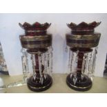 A pair of Victorian ruby glass lustres, with gilt decoration and clear glass droppers, height 13.
