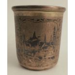 A Russian niello beaker, decorated with two reserves of cityscapes, with scrolls, marked for 1857,