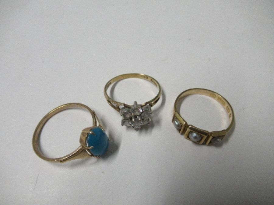 A 15 carat gold seed pearl set ring, together with a 9 carat gold oval turquoise ring, and a 9 carat