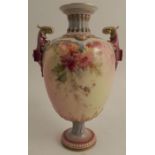 A Royal Worcester pedestal vase, decorated with flowers, having a pair of purple handles, to a