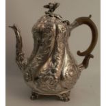 A Georgian silver coffee pot, the baluster shaped body decorated with flowers and leaves, with