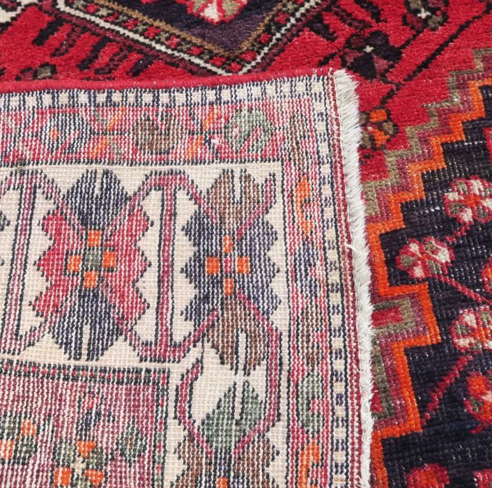 An Eastern style rug, the red ground decorated with repeating symbols, 55ins x 80ins - Image 3 of 3