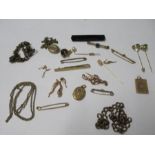 A quantity of tie clips, brooches, charms and lockets