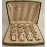 A cased set of twelve French silver shot cups, with a ribbed band of decoration, height 1.5ins - one