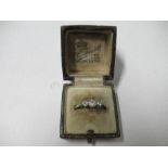 An 18carat gold and platinum three stone diamond ring, finger size S