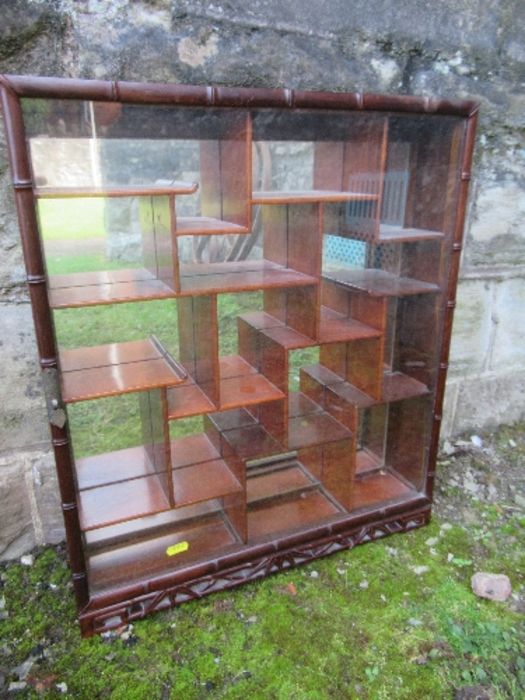 An Eastern hardwood  hanging display cabinet, height 23ins, width 19ins