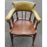 A mahogany desk chair, the curved back with upholstered upper section, raised on turned spindles and