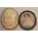 A small oval miniature, of a young girl in a blue dress, max diameter 3.25ins,  in a hinged