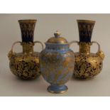 A pair of Crown Derby vases, decorated with gilt animals and leaves to a deep blue ground, having