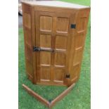 Wilf Squirrel Man Hutchinson, an oak corner cabinet, with panelled door, width 27.5ins, height 36.