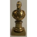 A carved brass bust of Wellington, raised on a short column, on a square base, height 8ins