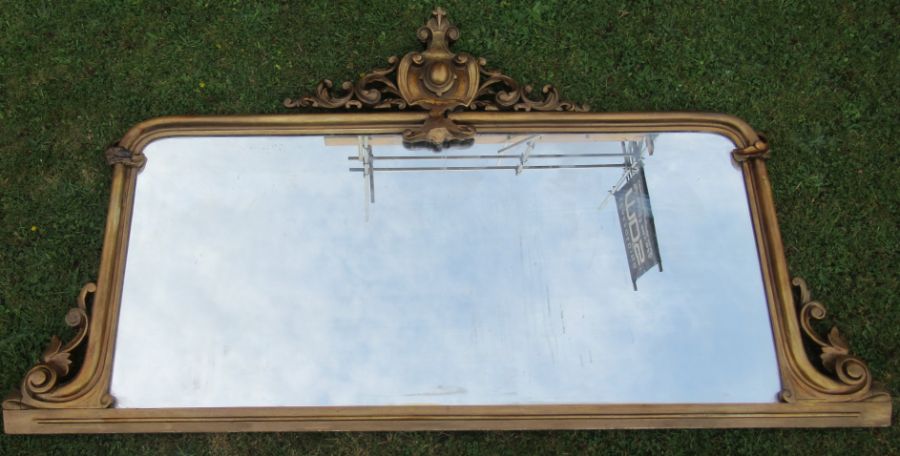 A gilt framed over mantel mirror, of rectangular form, with scroll and leaf decoration, overall