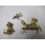 A yellow metal horse brooch, a 9ct gold duck pendant, and a 9ct gold poodle brooch, 27g gross