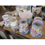 Four Poole pottery vases, together with a cache pot, and another vase, heights 6.5ins and down , the