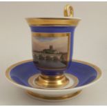 A 19th century French porcelain cup and saucer, with a blue ground reserving a painted panel of