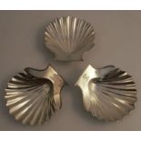 A set of three Georgian silver shell butter dishes, on whelk shell supports, engraved with a