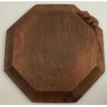 A Robert Mouseman Thompson oak octagonal teapot stand, carved with a mouse, 7.5ins x 7.5ins