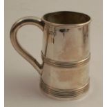 A silver mug, with ribbed bands to the tapered body, London 1900, maker Thomas Bradbury & Sons,