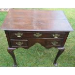 An Antique oak lowboy, fitted one long drawer and two short drawers, raised on cabriole legs and pad