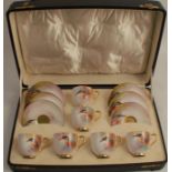 A Royal Worcester cased coffee set, comprising six cups and saucers, decorated with kingfishers on a