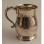 An 18th century silver mug, of baluster form, London 1739, weight 11oz, height 5ins - handle may