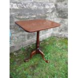 A mahogany occasional table, having rectangular top raised on a turned column, terminating in out