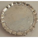 An 18th century silver card tray, with shell ogee border and engraved band to the centre, raised