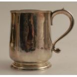 An 18th century silver mug, with scroll handle, London 1731, weight 6oz, height 3.75ins - signs of a