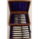 A cased set of six silver and mother of pearl fruit knives and forks, with engraved blades,