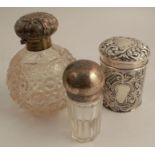 A silver covered dressing table pot, of cylindrical form, heavily embossed with lattice and scrolls,