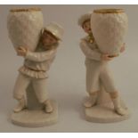 Two 19th century Royal Worcester figures, of boys carrying baskets, in white with gilt highlights,