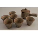 A Japanese Hagi ware set, comprising a tea pot and six cups no obvious damage or restoration