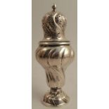 A Continental silver sugar caster, with engraved decoration to the pierced cover, with wrythern