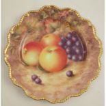 A Royal Worcester plate, decorated with hand painted fruit by H Ayrton, to a shaped gilt edge, dated